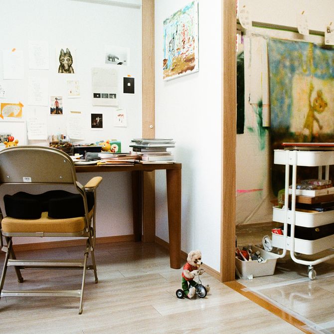 Chen Wei Ting's studio with collections of images taped to the wall, toys and paintings hung