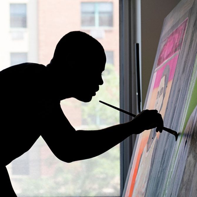 Silhouette of Marcus Brutus adding details to a canvas using a large paintbrush