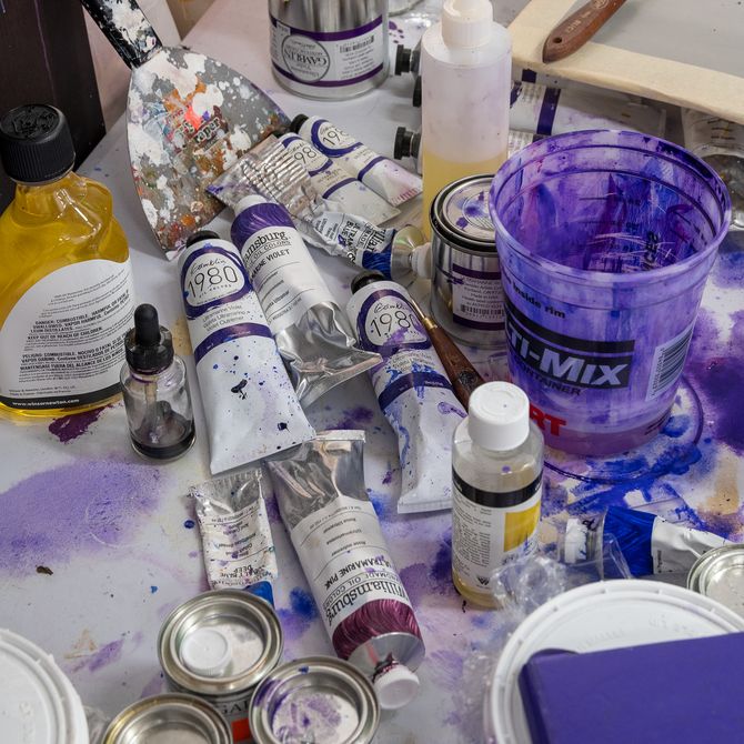 tubes and pots of paint on a table