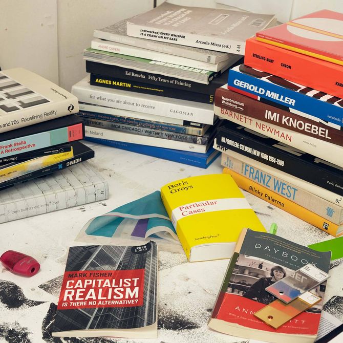 books on a desk in the artist's Jonny Niesche studio - close up shot
