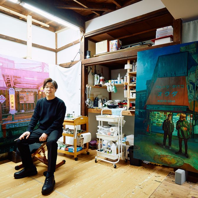 Keita Morimoto sits in his studio amongst paintings