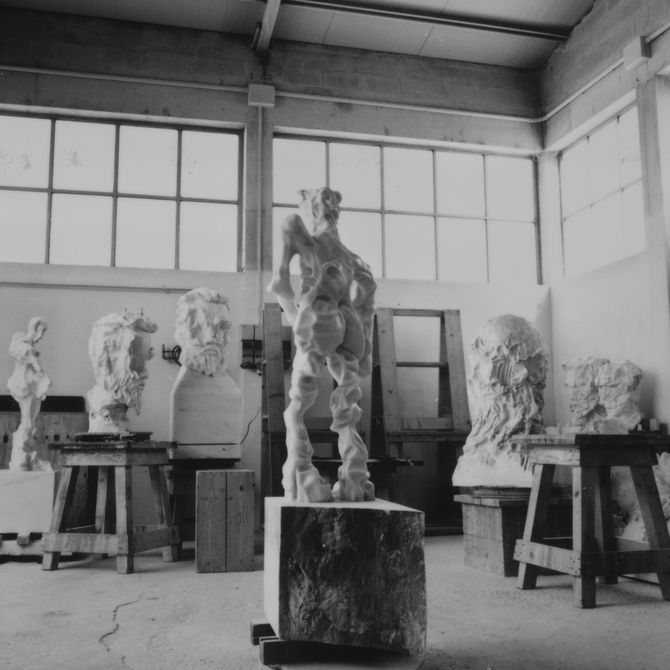 selection of large marble busts and freestanding sculptures in artist's studio