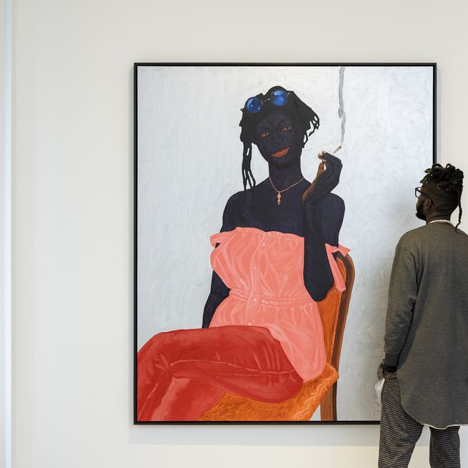 Kwesi Botchway standing in front of a figurative painting