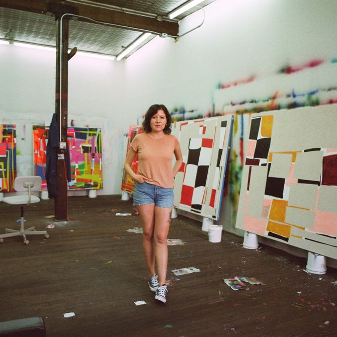 Trudy Benson stood in her studio surrounded by four large paintings