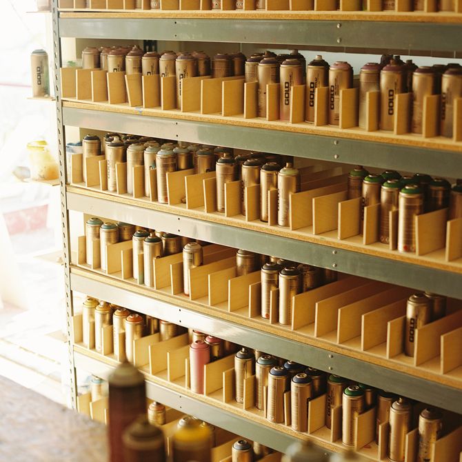 stacks of spray paints lined up on shelves