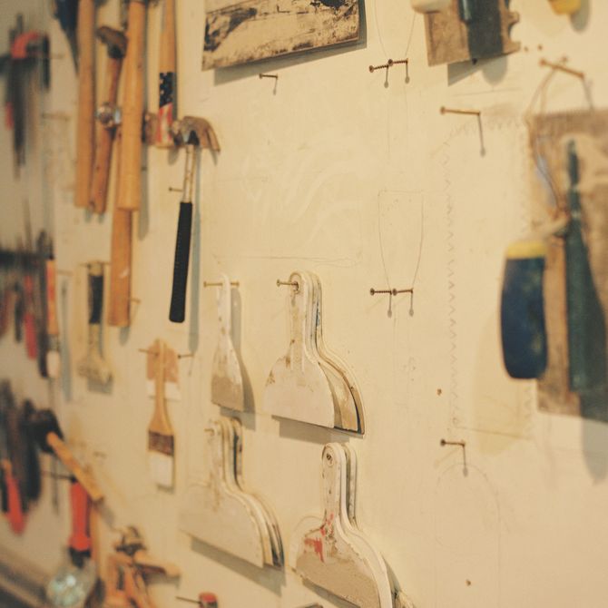 View of a range of tools hanging on a white wall