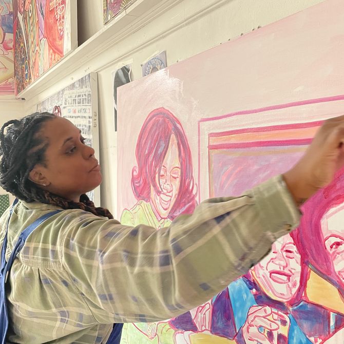 artist Esiri Erheriene-Essi reaching across a painting in her studio