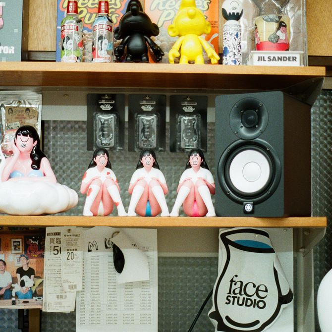 Small figurines and a speaker on wooden shelves