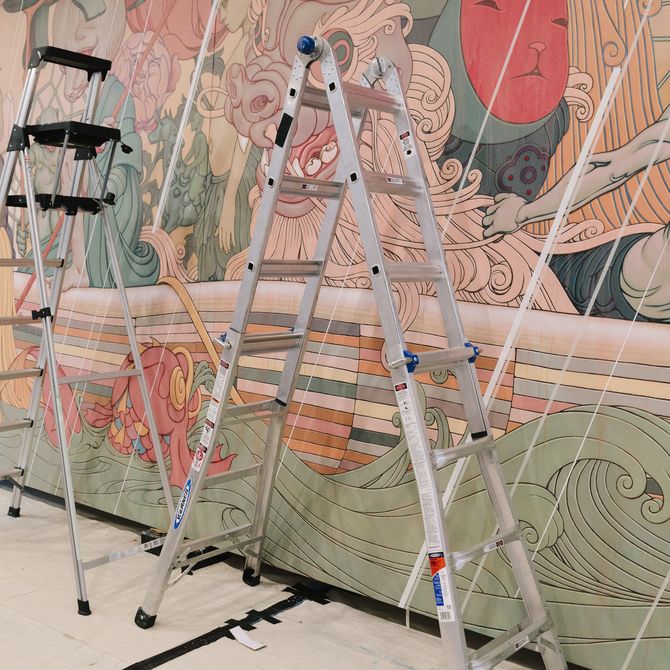two ladders stood in front of large scale wall painting