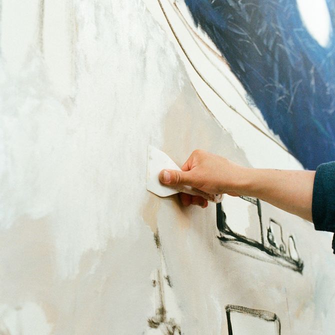 Yuichi painting large canvas in his studio