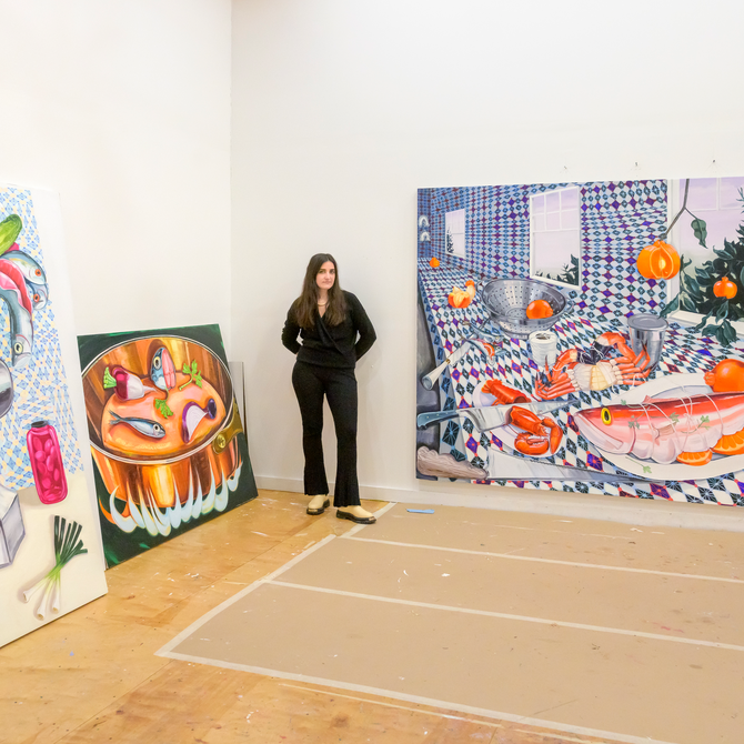 Nikki Maloof stands in her studio amongst huge paintings