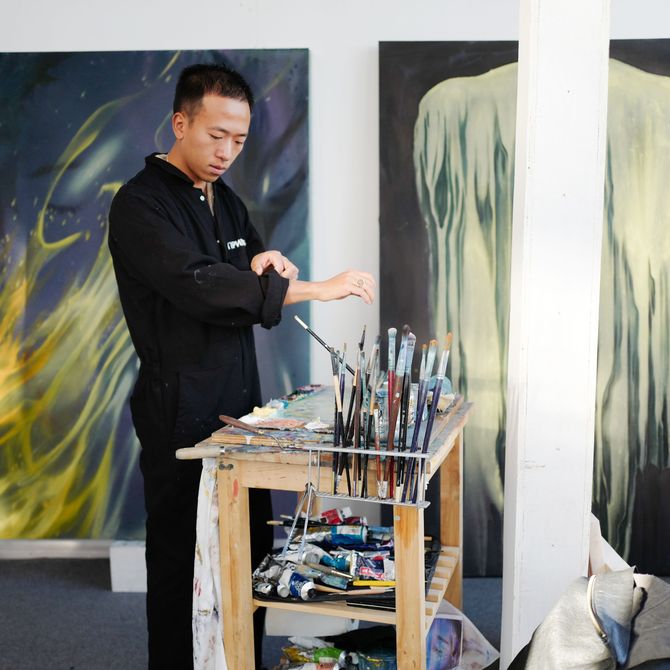 Liang Fu rolls up his sleeves in his studio