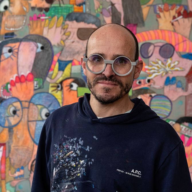Rafa Macarron stood in front of a colourful painting