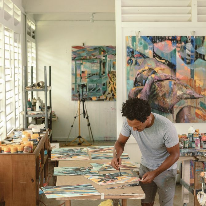 Che Lovelace painting in his studio