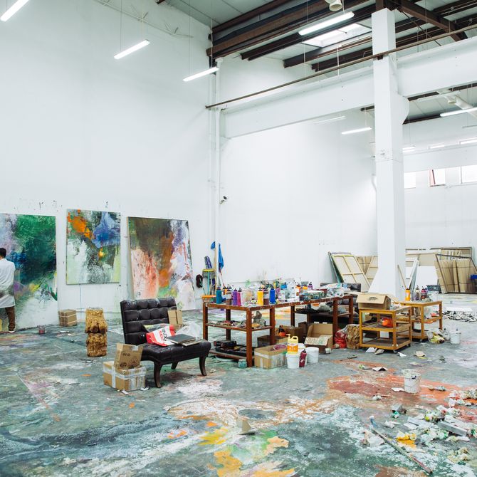 Wang Yan Cheng in his very large studio space where the floor is covered in paint