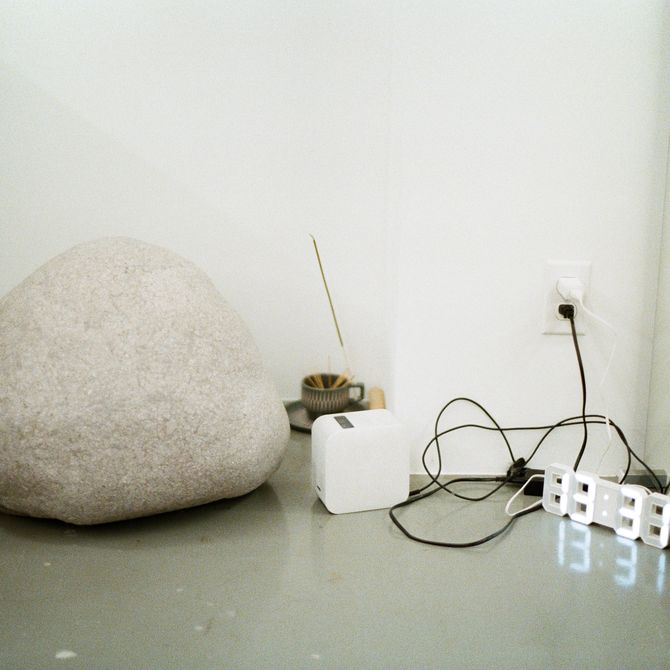 A large rock next to cables on the floor