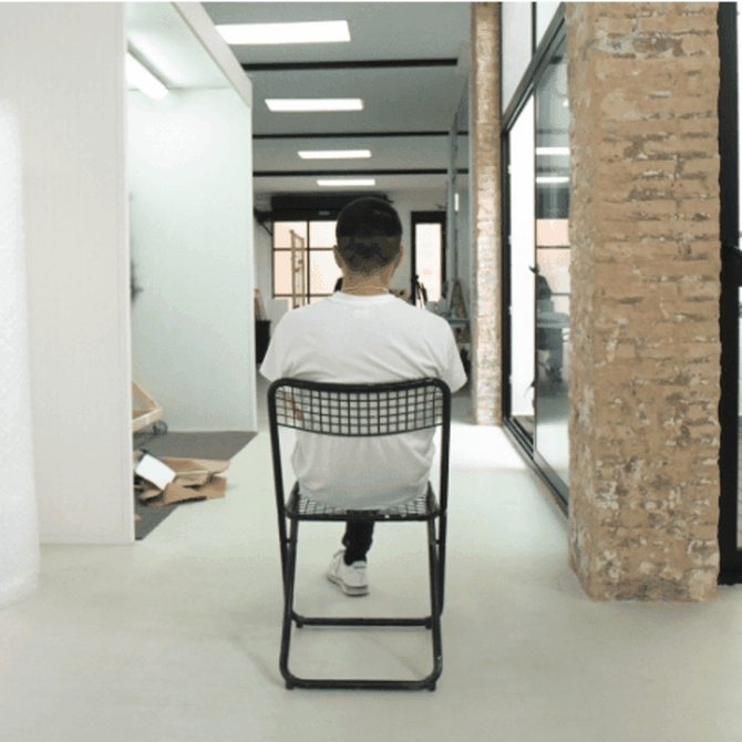 Felipe Pantone sat on a chair facing away from the camera