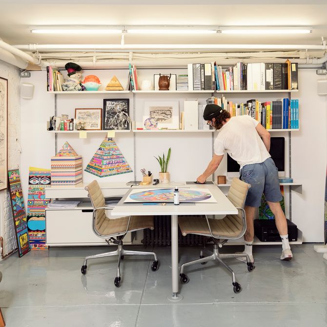 Erik Parker organises his desk in his studio