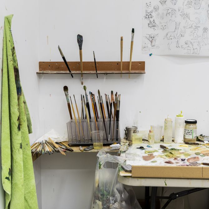 paintbrushes and pots located in the artist's studio