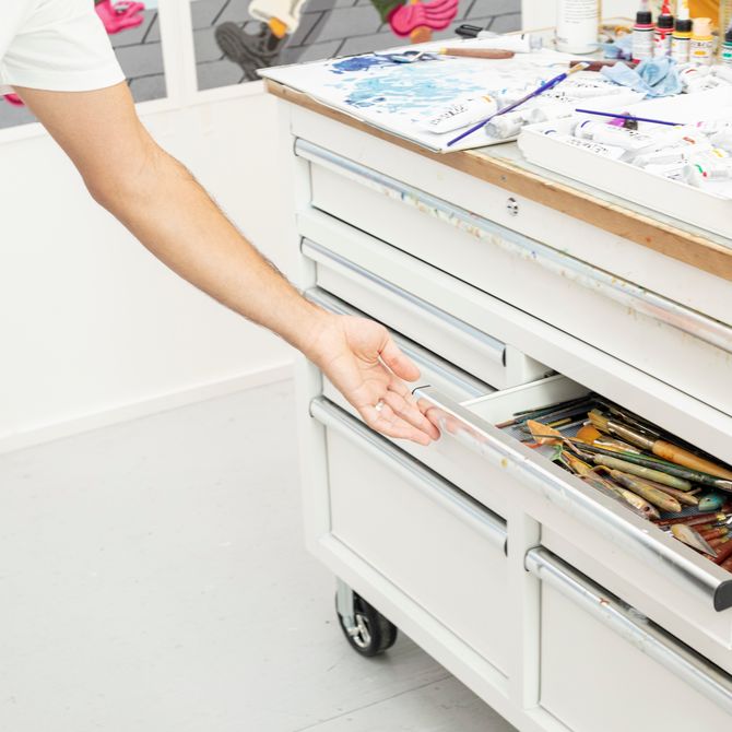 Nicasio Fernandez opening a drawer in his studio