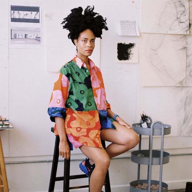 Kenturah Davis sits on a chair in her studio