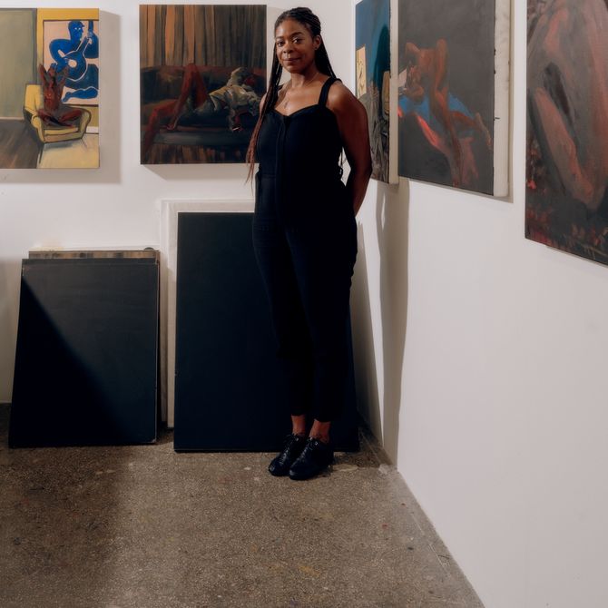 Danielle Mckinney standing amongst her artworks in studio