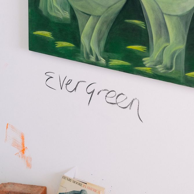 'Evergreen' text on studio wall under green painting