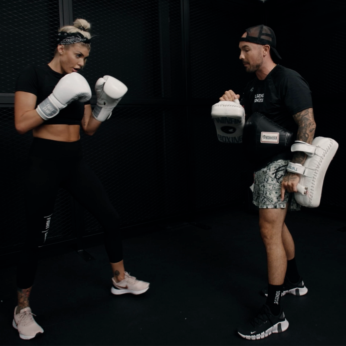Aaron Swenson showing how to hold pads for knees