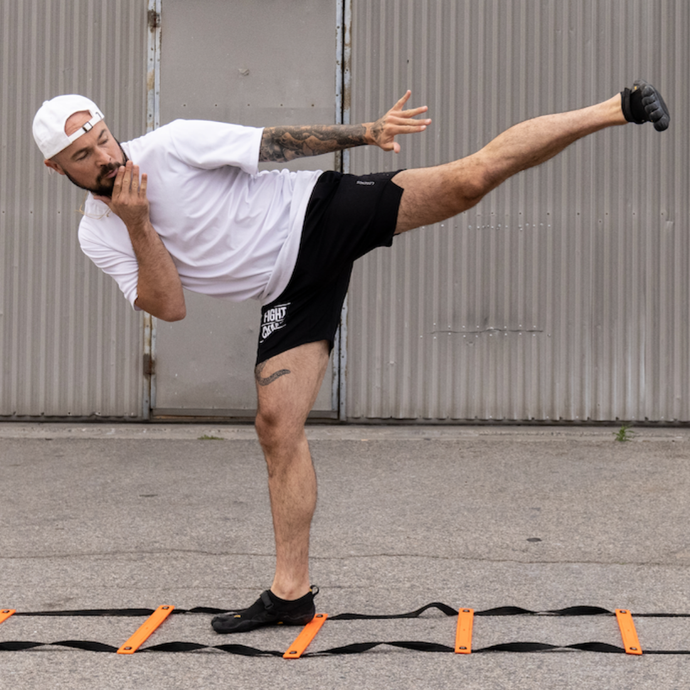 Aaron Swenson doing a bonus kick for agility ladder drills
