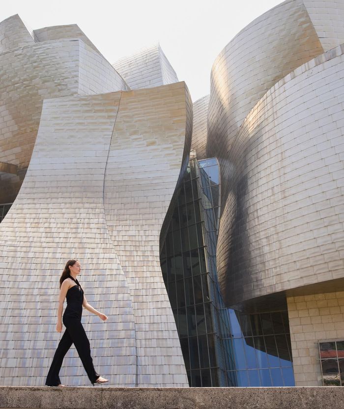 Woman walking in front of the Guggenheim Bilbao