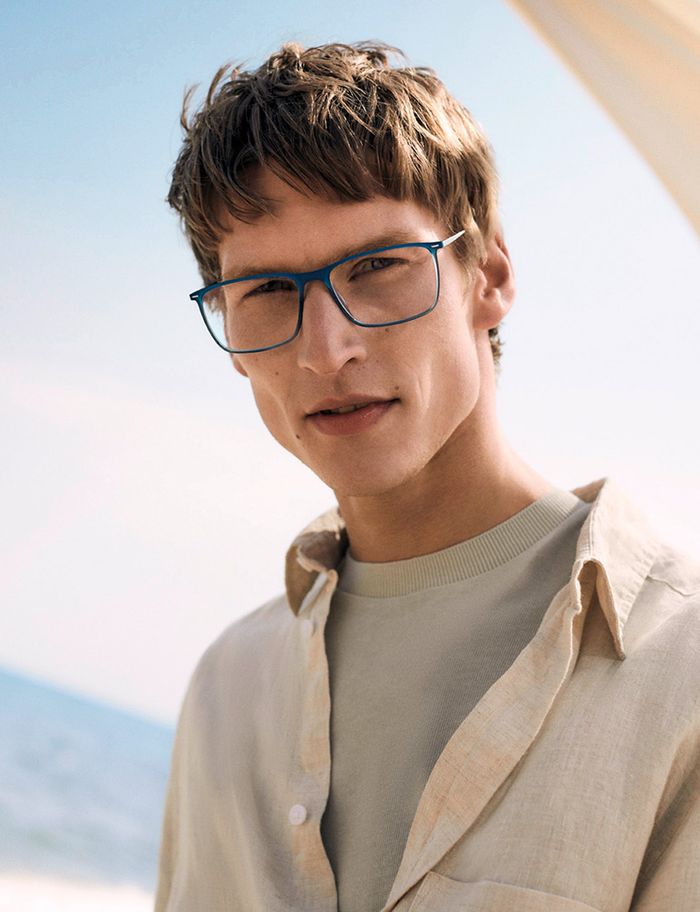 man at the beach wearing blue colored full-rim glasses