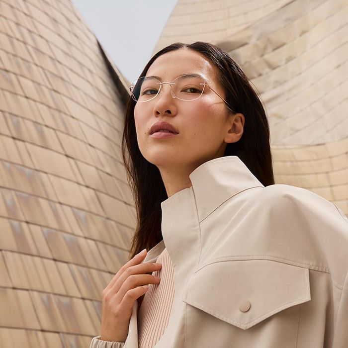 woman standing in front of the Guggenheim Bilbao Museum wearing The Refined collection