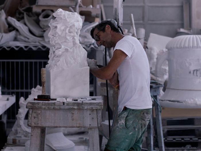artist Kevin Francis Gray working on one of his marble sculptures in the studio