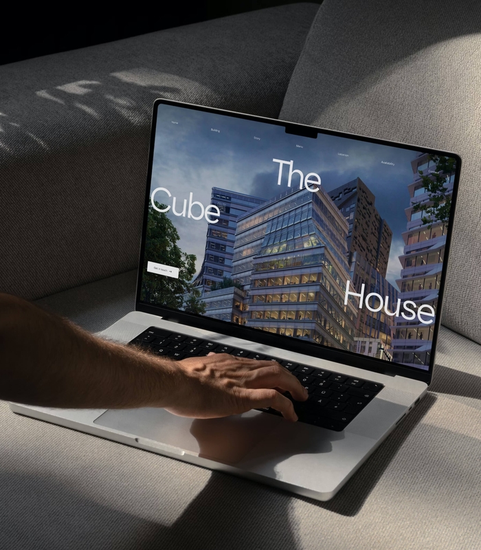 Laptop with The CubeHouse website on screen