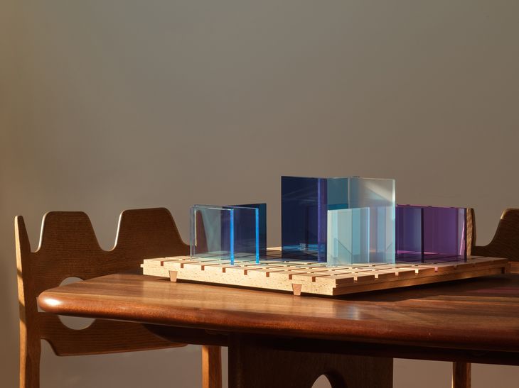 glass sculpture on wooden dining table