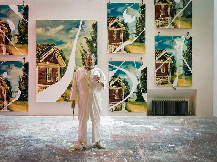 Julian Schnabel wearing white overalls in his studio