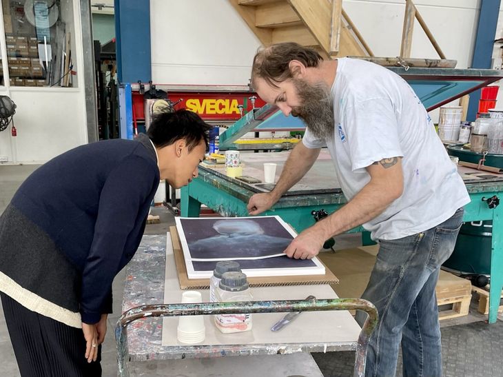 Liang Fu inspecting print