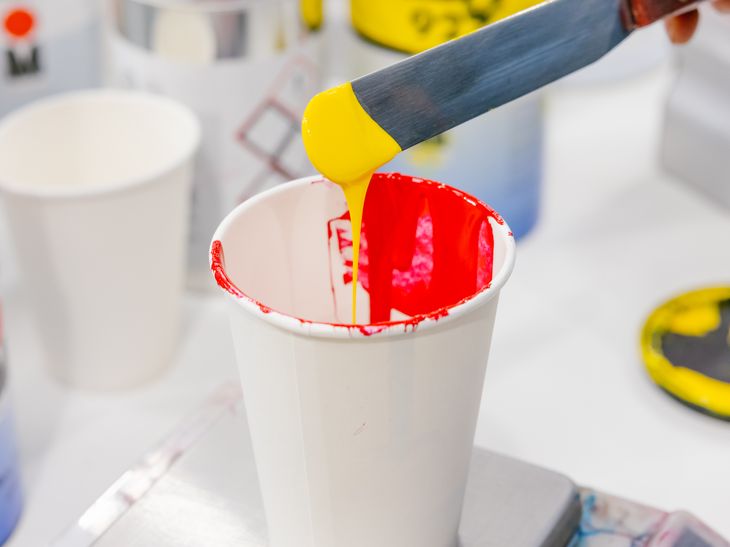 yellow and red paint mixing