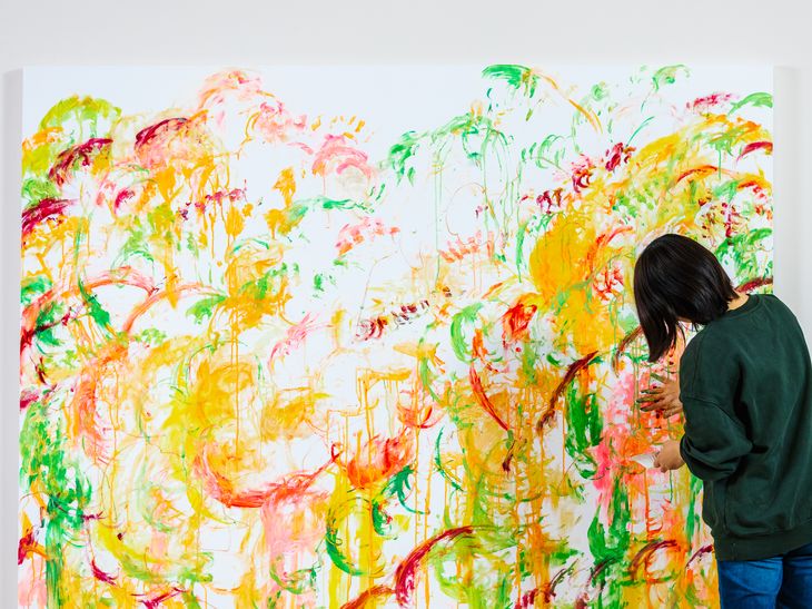 Ayako Rokkaku painting a large canvas, live