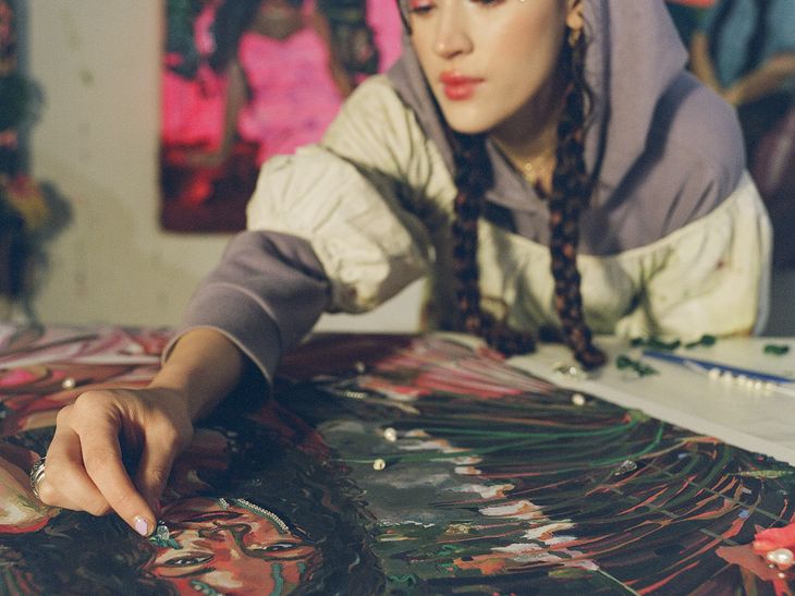 Gisela hand finishing her print in her studio