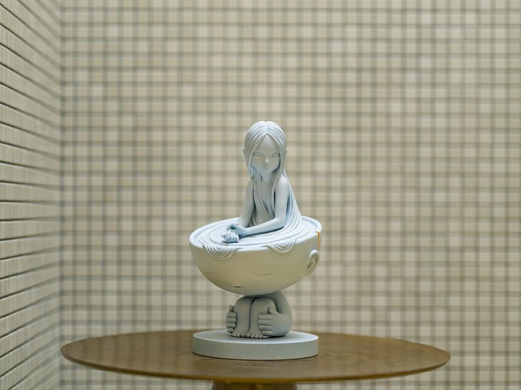 a James Jean marble sculpture photographed in-situ in a marble shower on a bronze tabletop