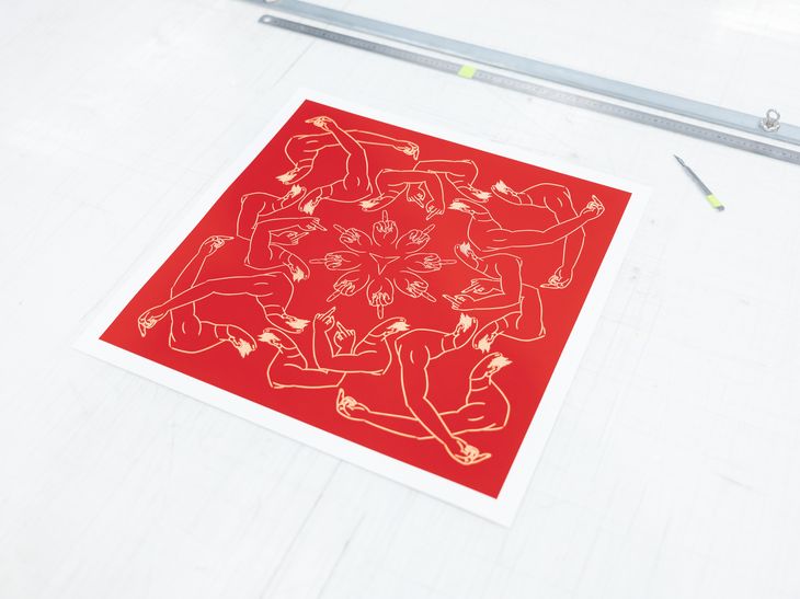 square red print laid flat on a work bench next to a scalpel and metal ruler