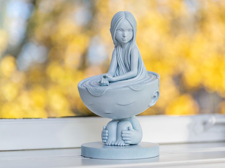 a James Jean marble sculpture placed on a white windowsill