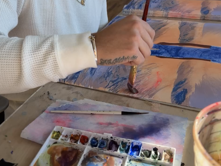 a video still of the artist hand-finishing in watercolour