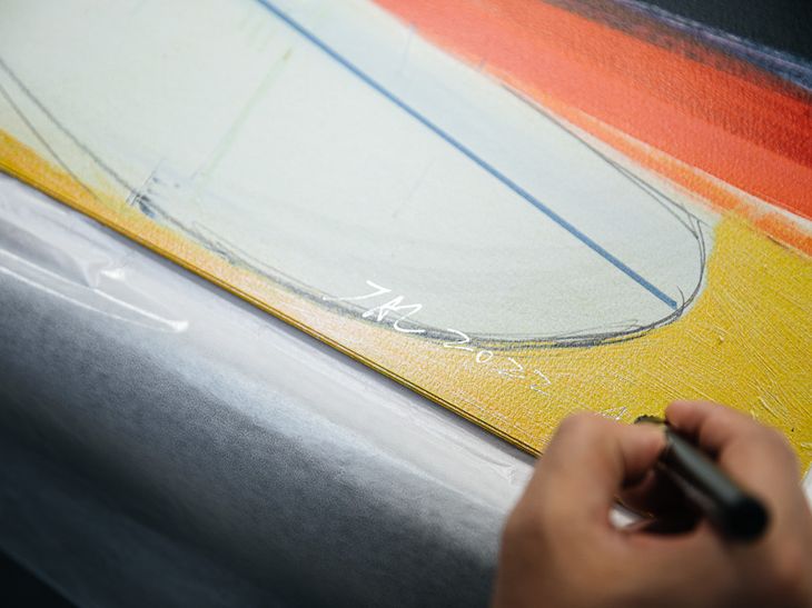 Jia Aili intricately hand-finishing his prints in pen and acrylic
