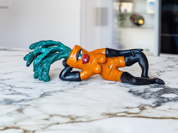 a reclining carrot sculpture placed on a marble kitchentop
