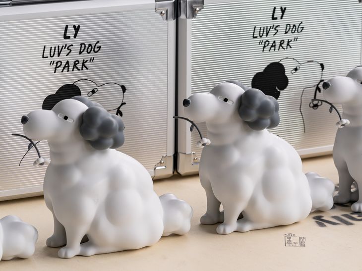 dog sculptures in front of a wall of metal cases