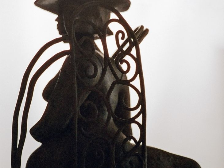 dramatically lit, patinated bronze sculpture
