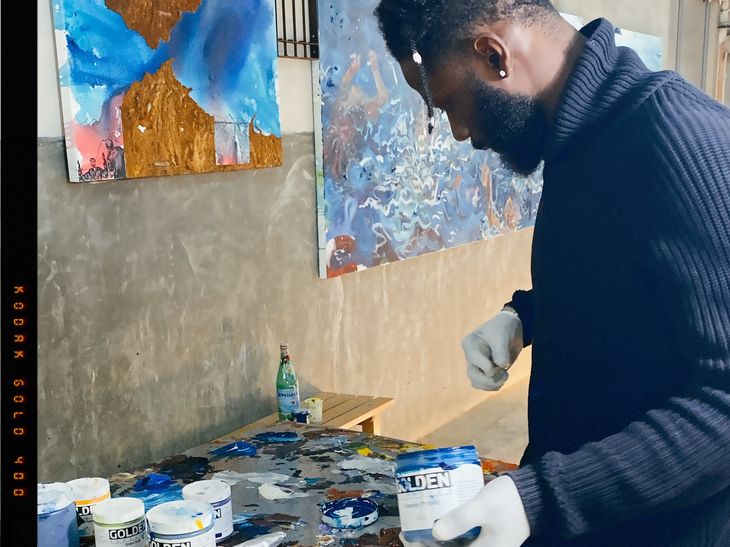 artist Ludovic Nkoth painting in his studio