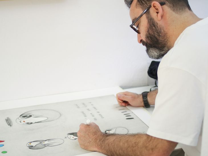 artist hand-finishing a print in the lithography workshop, the process behind First Look by Javier Calleja